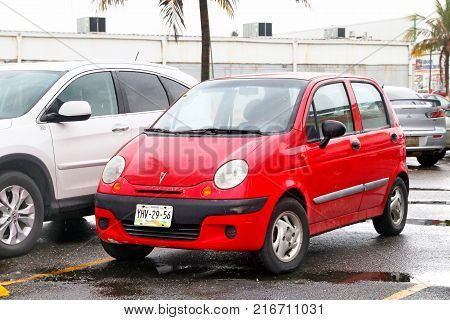 Coatzacoalcos Mexico - June 2 2017: Red compact car Pontiac Matiz in the city street.
