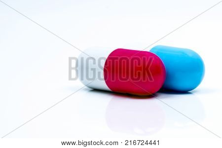 Two capsule pills isolated on white background. Global healthcare concept.