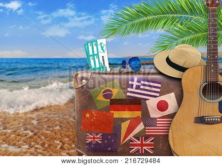 Concept of summer traveling with old suitcase and guitar