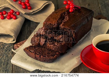 Chocolate-banana Loaf cake on paper  on wooden background