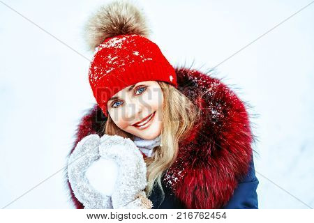 winter holidays, christmas and people concept - close up of woman holding snowball outdoors
