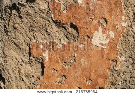 Old crumbling plaster closeup Old crumbling weathered grunge plaster of clay wall surface closeup as background