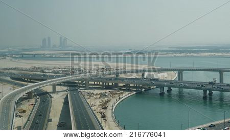 Aerial View On Traffic Bridge Over River In Sunny Autumn Day Cars On Bridge. View Of Traffic Jam On 