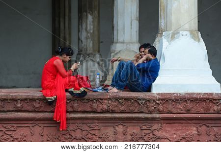 Agra India - Jul 13 2015. People sitting at Diwan-i-Aam Palace of Agra Fort in Agra India. The fort was main residence of the emperors of the Mughal Dynasty till 1638.