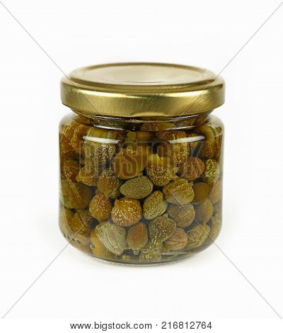 Close up of one small glass jar of pickled capers over white background low angle view