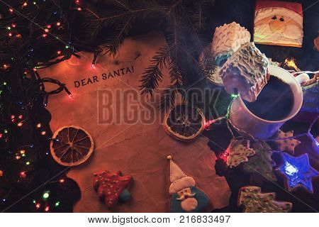 Letter for Santa on decorated chrismas background with gingerbread coocies and garland