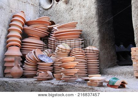 Preparing clay pottery for firing in adobe furnace. Traditional moroccan berber craft, Fez, Morocco, North Africa