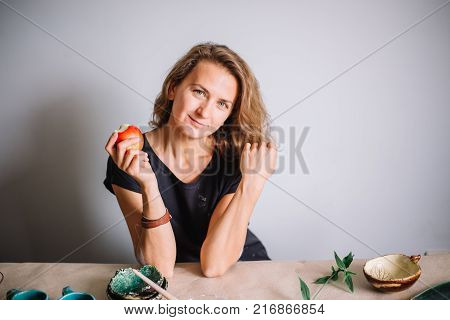 potter, tools, ceramics art concept - handsome young brunette female smiling.