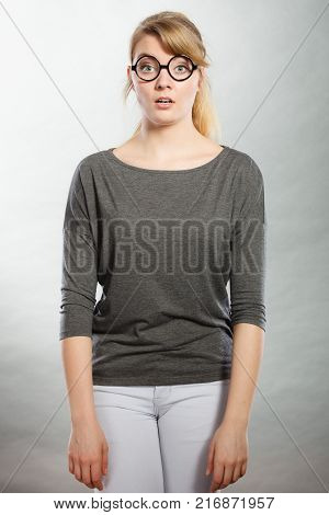 Shock and disbelief concept. Surprised astonished girl with wide open mouth. Amazed female looking very shocked. Facial expression and body language.