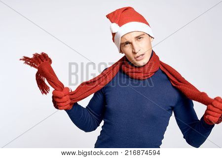 man in gloves holds his hands a scarf, a light background, a new year.