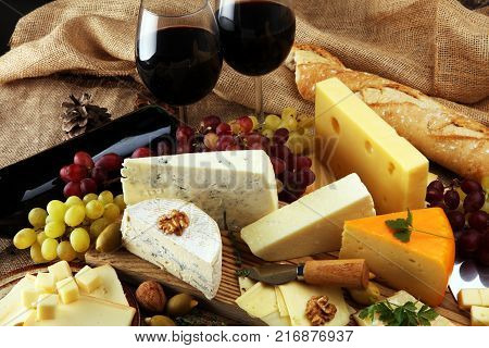 various types of cheese on rustic wooden table