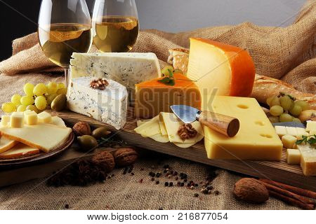 various types of cheese on rustic wooden table