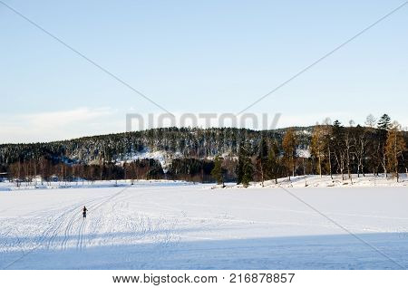A person practicing ski on the frozen lake of Bogstadvannet in Oslo, Norway. Alone in nature