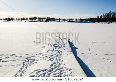 Jetty in a frozen lake covered by snow in Bogstadvannet, Oslo Norway. Tranquility and peace