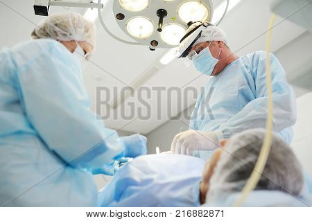 surgeons operate on a patient in the background Surgical Lamp