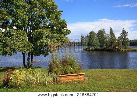Beautiful summer landscape with a river and flowers on the shore. Latgale. Latvia