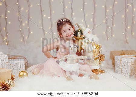 Portrait of white Caucasian children friends siblings celebrating Christmas or New Year. Little cute adorable girl and boy in studio with winter holiday decoration