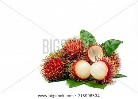 Closeup of fresh red ripe rambutan (Nephelium lappaceum) with leaves isolated on white background. Thai dessert sweet fruits. Tropical fruit.