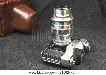 DONETSK, UKRAINE - May 07, 2016: old soviet film SLR camera Zenit - B with lens Jupiter-11, for use with 35 mm film, made in USSR in 1968 - 1973, manufactured by KMZ, with original leather case