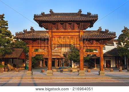 Wuzhen, China - June 24, 2016: Chinese arch, entrance to Park. Wuzhen water village is Shanghai tourist attraction with more than 100000 visitors per year. Wuzhen is part of Tongxiang, located in northern Zhejiang Province, China.
