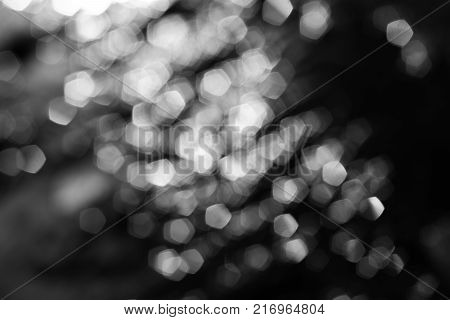 Monochrome hexagonal bokeh, circles unfocused background water