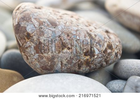 boulders and colorful pebbles on the beach on a warm summer day