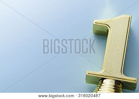 Textured Decorative Gold Winners Trophy Number One Over A Grey Stdio Background With Copy Space Plac