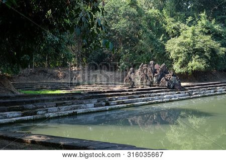 Small Sanctuary In Cambodia. Medieval Khmer Baray. A Tropical Forest.