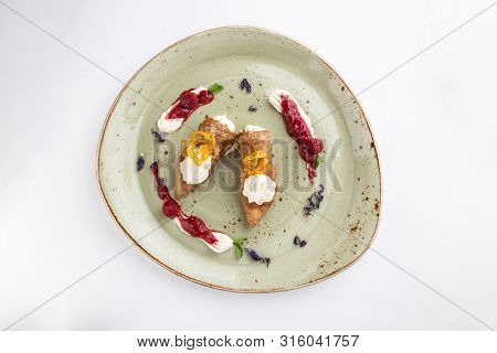 Fresh Italian Cannoli With Vanilla Cream And Strawberry Sauce On Green Plate Isolated On White Backg
