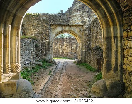 Portal In Romanesque Style, Corridor Between Stone Walls. This Portal Is Located In The Fortress Of 