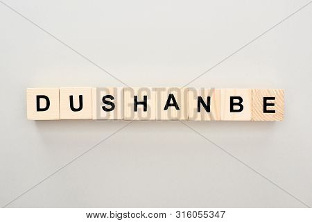 Top View Of Wooden Blocks With Dushanbe Lettering On Grey Background