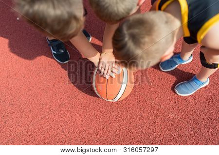 Kids Basketball Team. Young Basketball Players Holding Balls On Basketball Court. Basketball Horizon