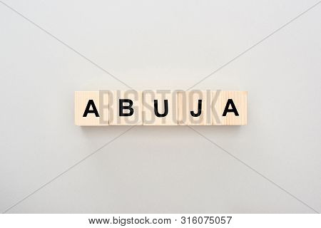 Top View Of Wooden Blocks With Abuja Lettering On Grey Background