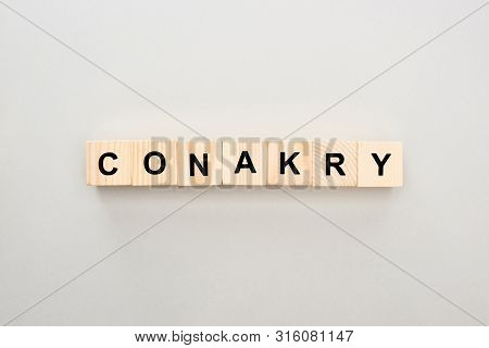Top View Of Wooden Blocks With Conakry Lettering On Grey Background