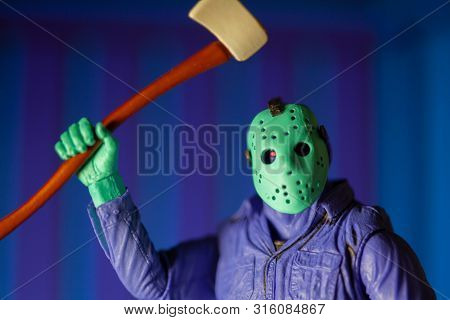 AUG 6 2019: recreation of a scene from the Nintendo NES 8-Bit Friday the 13th video game showing Jason Voorhees in day glow colors - Neca GameStop exclusive action figure