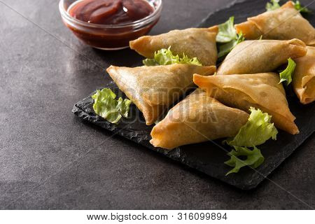 Samsa Or Samosas With Meat And Vegetables On Black Background. Traditional Indian Food. Copyspace