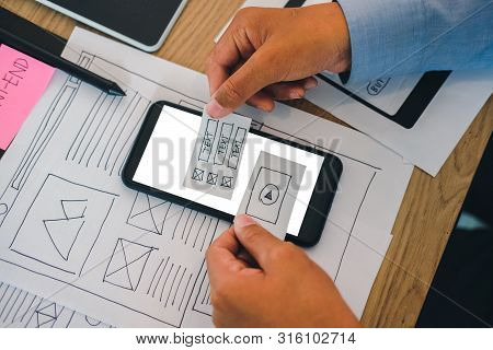 User Experience Ux Designer Designing Web On Smart Phone Layout. Ui Developer Planning Working On Mo