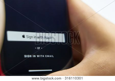 Bishkek, Kyrgyzstan - June 6, 2019: Sign In With Apple Button For Your Privacy. Man Holds A Smartpho