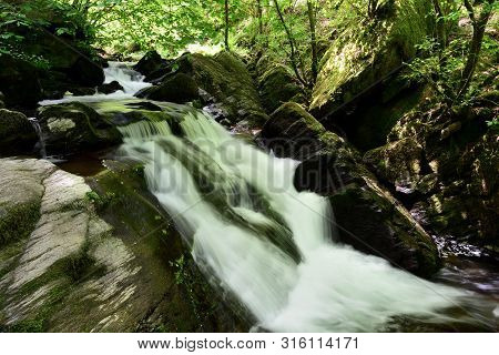 Long Exposure Of A Waterfall At Watersmeet In Devon