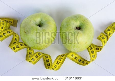 Sport Healthy Nutrition Green Apple And Yellow Measuring Tape On White Background