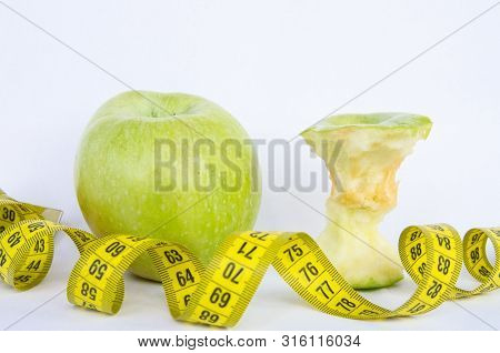 Sport Healthy Nutrition Green Apple And Yellow Measuring Tape On White Background
