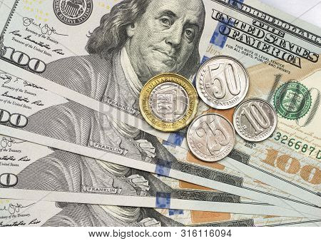 Venezuelan Coin On Top Of Dollar Bills For Financial And Investment Concepts