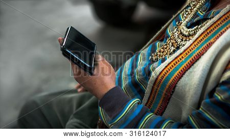 Close Up Of Aboriginal Hand Using Smartphone And Dressed A Traditional Clothes Of The Tribe. Taiwane