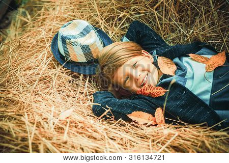 Autumn Clothing And Color Kids Trends. Boy On A Breeze In An Autumn Village. Autumn Child Boy With A