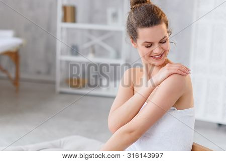 Cute Caucasian Woman Applies Natural Moisturizer Cream On Gentle Smooth Skin After On The White Spa 