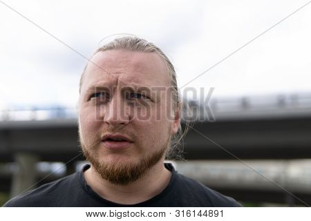 Portrait Of Man With Long Blond Hair. Closeup Portrait Of Young Man