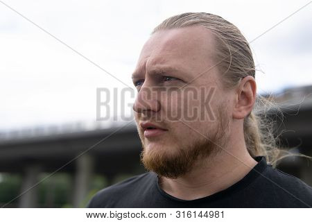 Portrait Of Man With Long Blond Hair. Closeup Portrait Of Young Man