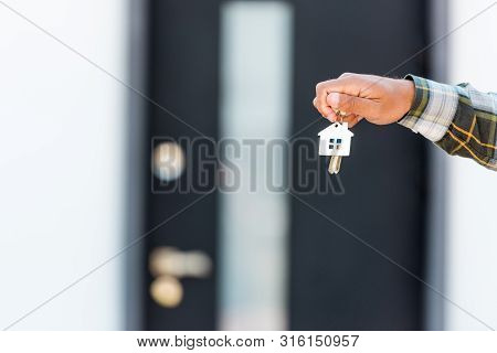 Cropped View Of Man Satnding Near House And Holding Key
