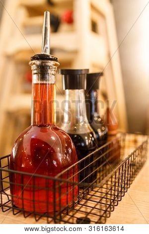 Chilli Oil, Soya Sauce Etc In Bottles On A Table