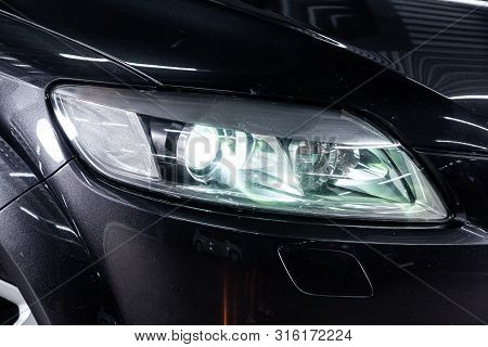 Novosibirsk, Russia - July 30, 2019: Audi Q7, Close-up Of The Headlight, Bumper, Wheel. Photography 